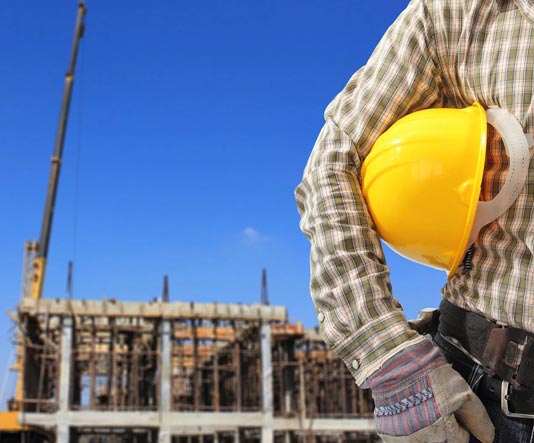 A person holding onto a yellow hard hat